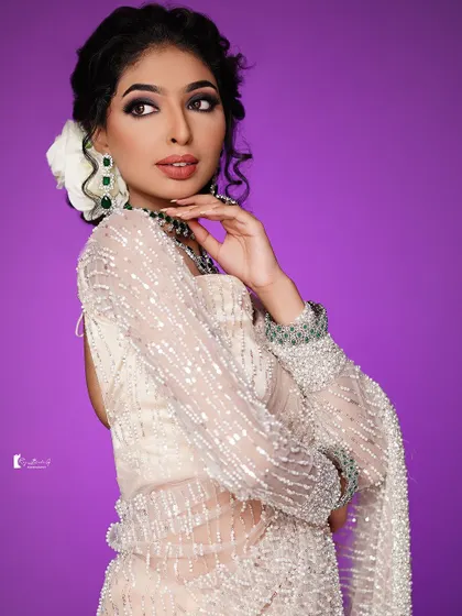 Another angle showcasing the intricate details of the hairstyle and the flawless makeup application.