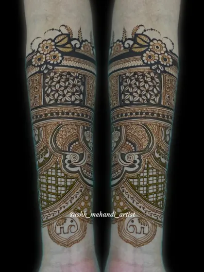 A close-up of the forearm portion of a bridal design. This showcases the intricate floral border and the detailed geometric and paisley patterns.