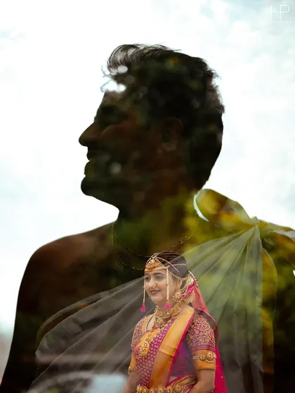 An artistic double exposure portrait blending the groom's silhouette with a beautiful image of his bride in her traditional wedding saree. This technique beautifully symbolizes their union.