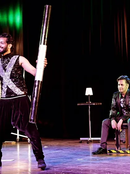 Another angle of the chair levitation, showing the setup and my assistant's role in the illusion. Teamwork is crucial for pulling off these large-scale stage acts safely and effectively.