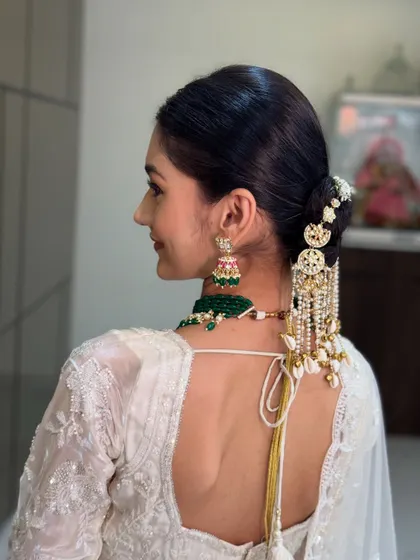 A side view of the elegant bridal bun, showing the perfect placement of the hair jewelry.
