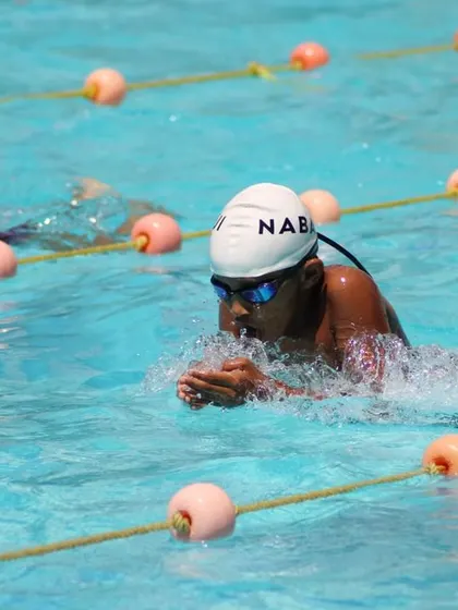 A swimmer executes a perfect breaststroke pull, showing the technical skills we teach.