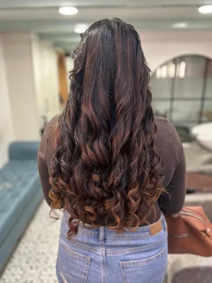 Look at the bounce and shine on these curls. This is the result of a fresh color service combined with expert styling to define each curl and show off the highlights.
