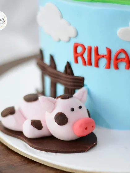 This little piggy is resting in a mud puddle made of chocolate. It's the small, fun details that make a cake special.