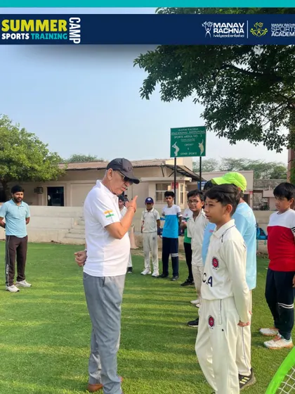 Sh. Sarkar Talwar sharing his wisdom with a young cricketer, a moment of inspiration that defines our summer camp experience.