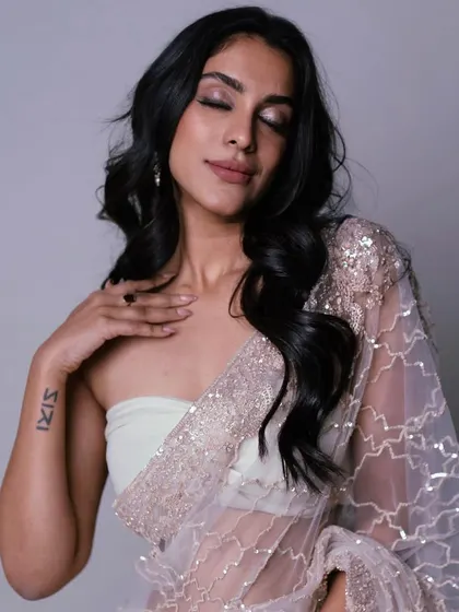 I'm obsessed with this elegant look. The closed-eye shot showcases the soft, shimmery eyeshadow that adds just a touch of glamour to the otherwise minimal makeup.