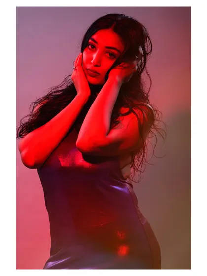 A portrait using colored gels to paint with light. The red light casts dramatic shadows and creates a bold, emotional atmosphere that is both modern and intense.