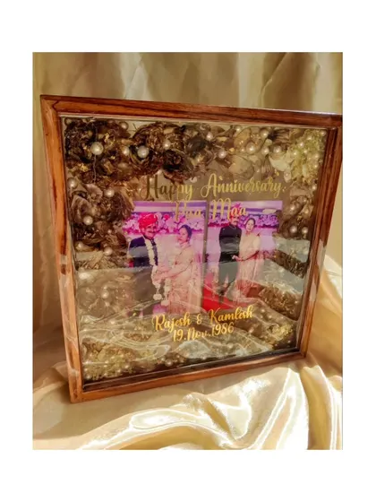 This custom anniversary frame is the perfect gift to honor your parents' love story. It combines their wedding photo with their preserved varmala, creating a priceless family treasure.