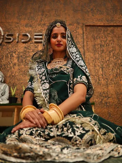 An invitation to my world. This photo was taken before the show, seated in my traditional green poshak, ready to welcome the audience to "Padharo Mhare Des".