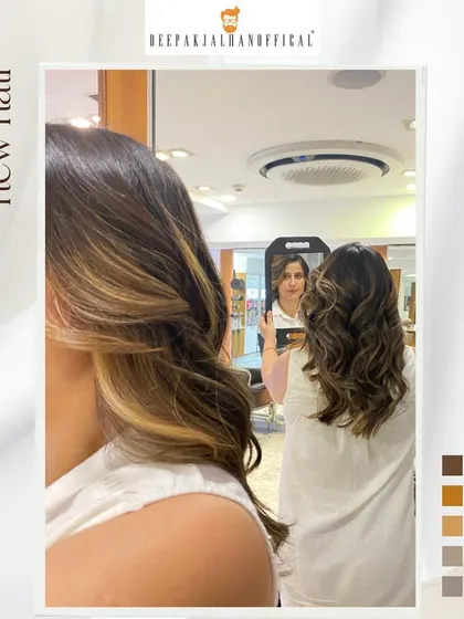 A mirror selfie capturing the fresh, glossy look of these sun-kissed highlights. This is a great low-maintenance color for adding brightness around the face.