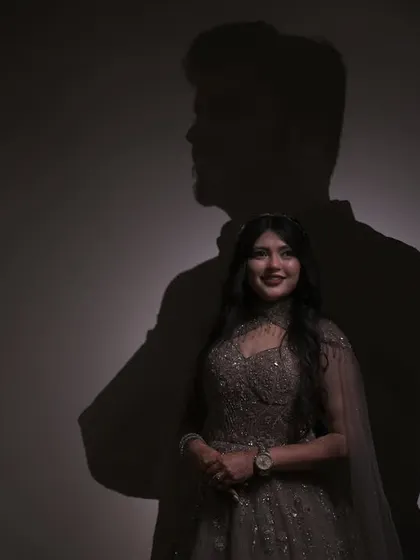 A creative exploration of love and connection. Using shadow play, this portrait tells a story of two people intertwined, where her smile is lit by his silhouette, showcasing my conceptual approach.