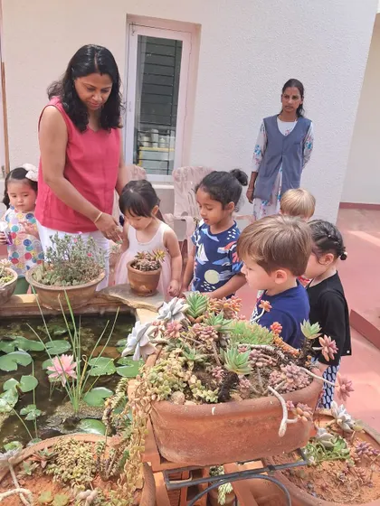 A homeowner shows the children her succulent garden, sharing her love for plants with our curious students.