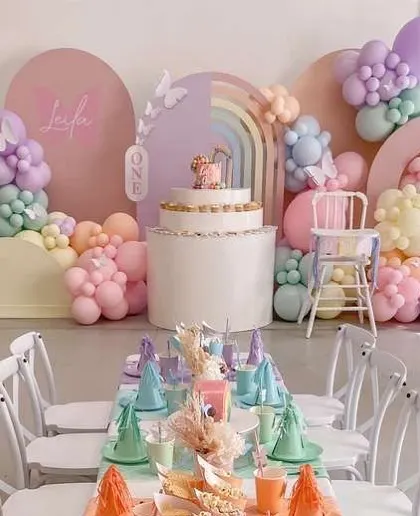 A whimsical pastel rainbow theme for a first birthday party. I can create custom backdrops, table settings, and high-chair decorations to match any theme you can imagine.