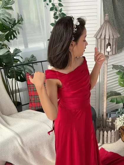 A solo portrait of the daughter in her beautiful red dress, looking like a little princess.