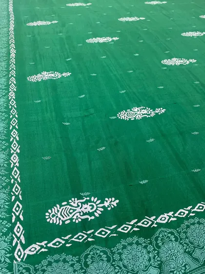 A beautiful emerald green saree gets a makeover with our custom block prints. The traditional paisley and geometric patterns give it a completely new and fresh look.