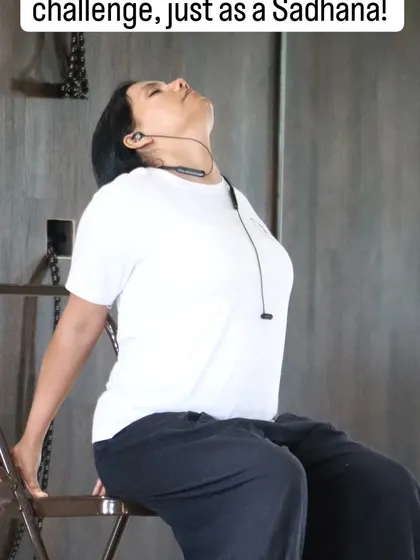 A student practices a supported backbend on a chair, a simple yet profound way to open the heart and release tension in the thoracic spine.