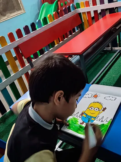 A student working on his Minion drawing in our studio, which is designed to be a happy and inspiring place for kids.