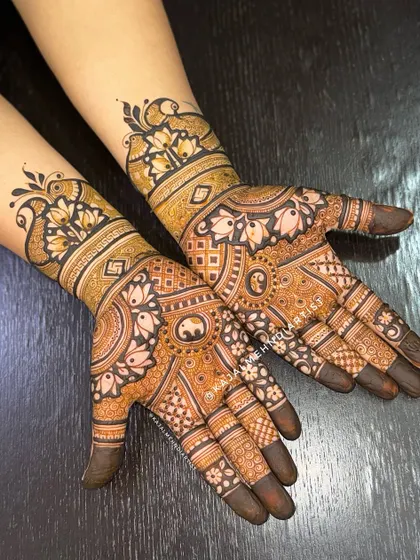 A stunning full-hand design for the groom's sister, featuring peacocks and lotuses.
