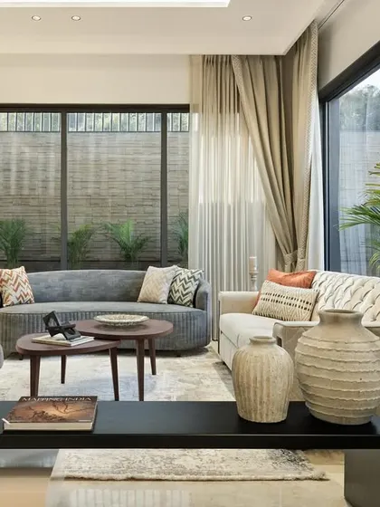 The ground floor living room is designed for hosting with ease. We curated a collection of our custom-made furniture, including the sculptural Drift Chair, against a backdrop of soft greys and natural textures, with large windows connecting the space to the surrounding greenery.