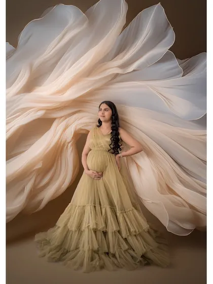 Another example of our fabric tossing artistry, this time with a soft, neutral-toned gown. The billowing fabric creates a sense of weightlessness and grace.