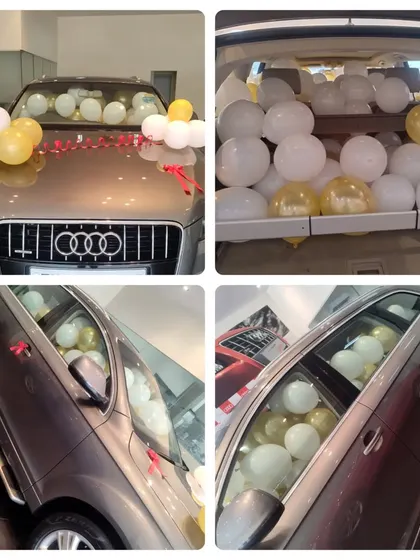A fun surprise car decoration, with the boot and interior filled with balloons for a special gift reveal.