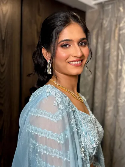 The complete sangeet look, showing how the makeup, hair, and outfit create a harmonious and elegant style.