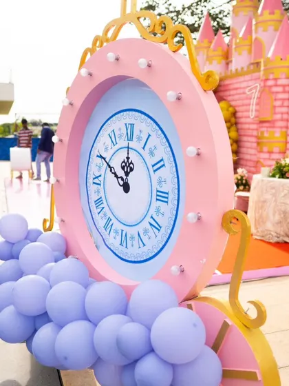 It's all about the details. This oversized clock prop, set against the backdrop of a pink castle, adds a touch of Cinderella's magic, reminding everyone it's time to celebrate before the clock strikes midnight.