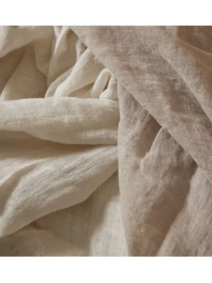 The 'Tiamo' fabric is a plain, piece-dyed sheer with a subtle puckered texture that creates a crinkled, relaxed look. It's a beautiful choice for soft, natural-feeling drapery.