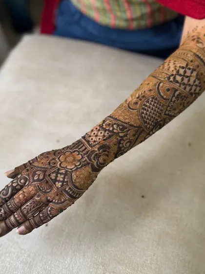 A beautiful design for the back of the hand and arm, featuring a central floral mandala and delicate check patterns.