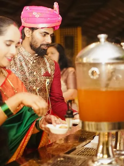 A couple enjoying the live pani puri counter at their wedding event. Live chaat stations are a must-have, bringing the vibrant flavours of Indian street food to any celebration.