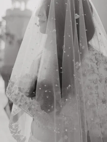 A delicate black and white close up of Priyanka through her veil, a soft and artistic bridal portrait.