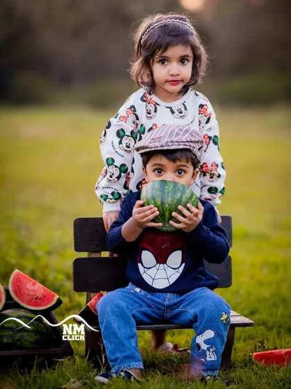 Summer days and sweet watermelons make for the cutest photos. This brother and sister duo had so much fun during their outdoor session, and we were there to capture their playful interaction.