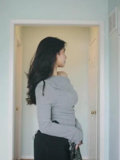 A profile shot highlighting my hair and the off-the-shoulder detail of the top.