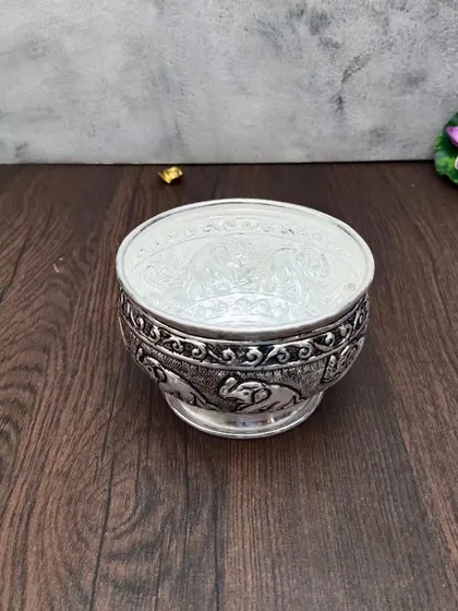 A top-down view of the elephant bowl, showing the shiny, smooth interior contrasting with the carved exterior.