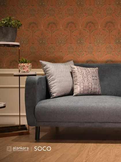 A full view of the Soco collection sofa, showcasing its minimalist design and versatile style against a patterned wallpaper backdrop.
