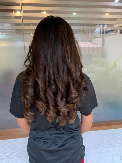 Caramel highlights and brown tones for Anjali's long hair.