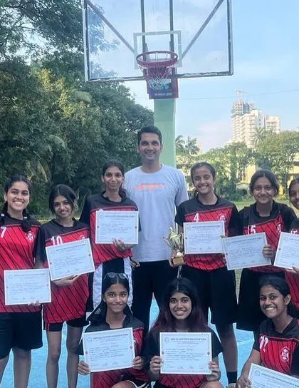 The St. Andrews girls' team proudly displaying their certificates and trophy. A well-deserved victory.