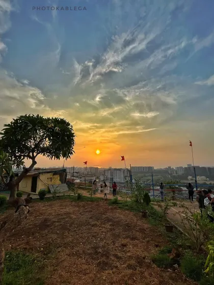A beautiful sunset view from atop Gilbert Hill, with the city skyline in the background.