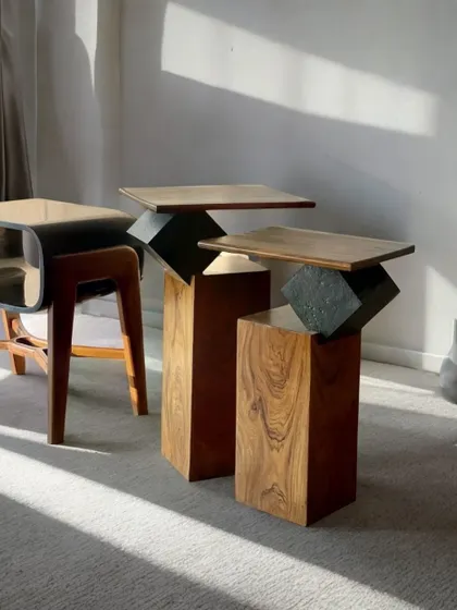 A collection of our side tables, including the "Roll the Dice" nesting tables, on display in our store. This image showcases the variety of materials and geometric forms we work with.