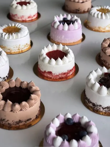 An array of our beautifully decorated mini cakes, each with its own unique flavour and design. A cake is always a good idea to start the day or celebrate a small win.