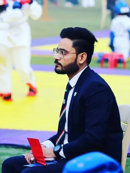 Observing a match from the sidelines. As an official, it is my duty to carefully watch every move to ensure accurate scoring and sportsmanlike conduct.