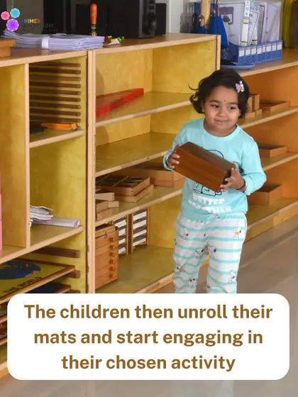 A child confidently chooses her work from the shelf and carries it to her mat, demonstrating the independence we nurture.