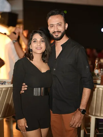 A happy couple posing together, enjoying the rooftop vibes.