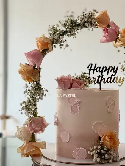 For a dreamy and elegant birthday, I created this beautiful cake with a tiara-like arch of fresh roses and baby's breath. The soft pastel pink ombre and delicate textures make it a truly special celebration cake.