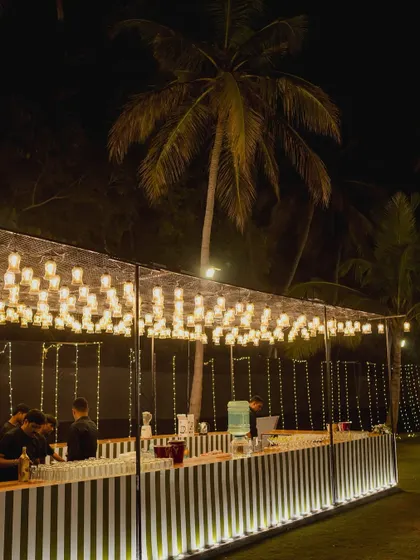 A custom-designed bar for a reception, featuring unique glass lighting and a sleek, modern design. Functional elements of your wedding can also be beautiful and stylish.
