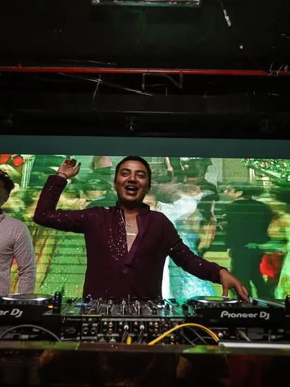 A great shot of me and my partner enjoying the music in front of a massive video wall. The visuals are always a key part of my performance.