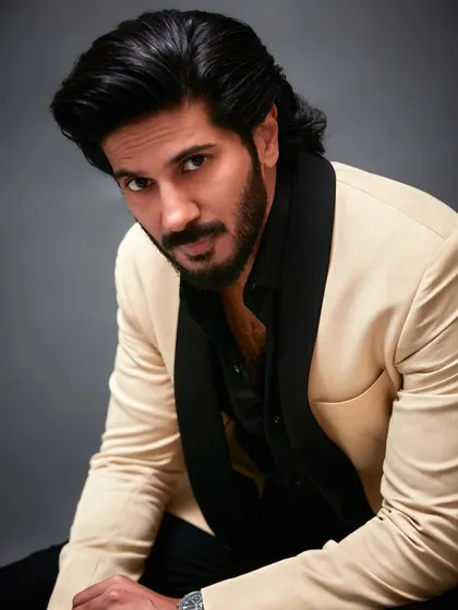 A portrait of Dulquer Salmaan for his GQ feature. The contrast of the cream jacket against the black lapel creates a striking visual that is both modern and timeless.