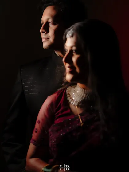 A moody and romantic portrait of a couple, using dramatic lighting to create a sense of intimacy and elegance.