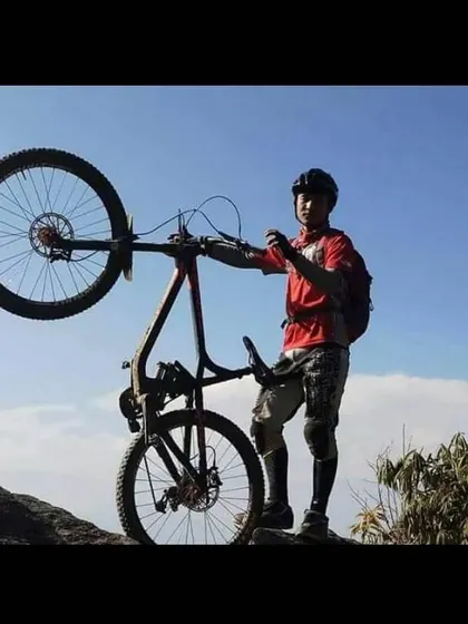 It's not all serious racing. Enjoying the moment after a tough climb in Bhutan. Bike handling skills like this wheelie are not just for show; they build balance and control that translate directly to better trail riding.