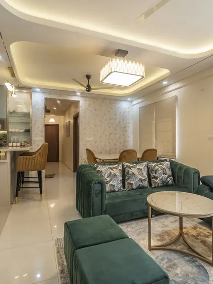 A wide shot of the living area, highlighting the custom pooja unit on the left. We ensure that every aspect of a client's lifestyle is integrated beautifully into the home's design.